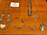 Overview of all silver and turquoise jewelry pieces laid out on wooden surface