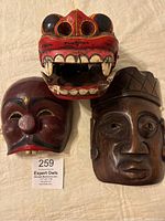 Three vintage Southeast Asian masks displayed together showing size, style and condition.