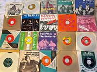 Full lot of 16 vintage 45 rpm singles arranged in a 4×4 grid