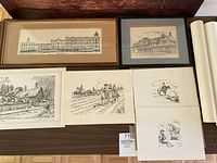 Framed sketch of Windsor Block street scene and multiple sketches laid out, rolled large prints visible on right