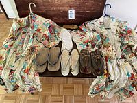 Full display of both vintage floral kimonos, three pairs of sandals, and tabi socks on wooden table.