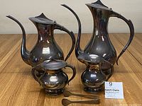 All five pieces displayed together on wood table