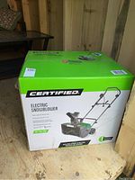 Front of sealed box showing 'Certified Electric Snowblower' branding