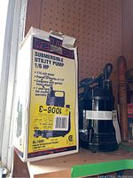 Photo of Red Lion Submersible Utility Pump and its original box showing front and side views with product details.