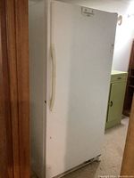 Front view of white upright freezer closed