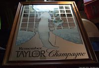 Photo of the Taylor Champagne bar mirror showing the woman in gown illustration with windowpane grid background and text.