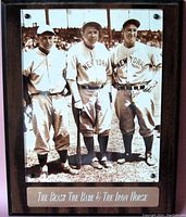 Plaque featuring a black and white photo of three New York baseball players, labeled The Beast, The Babe, and The Iron Horse with an engraved metal plate.