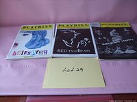 Photo showing three vintage theater Playbills arranged side by side against a pink background with a yellow sticky note marked Lot 29.