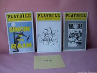 Photo showing three vintage Playbills from theater performances, including Singin' in the Rain, Peter Nero and Philly Pops, and Good Vibrations.