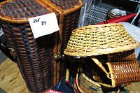 Large dark brown woven handbag with leather handles and a lighter dome-shaped lid basket