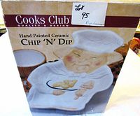 Box with hand painted ceramic chip n dip plate image of pig wearing chef hat and apron, branding 'Cooks Club'.