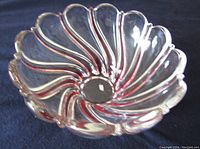 Top view showing the clear glass bowl with pink swirl pattern and scalloped edges.