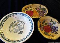 Set of a fruit motif platter and two matching bowls, one bowl with a recipe print visible.