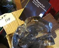 Clear plastic Wolfgang Puck ice bucket with coiled strainer and utensils in new condition with use and care booklet.