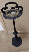 Full view of the black cast iron ashtray stand showing height, base, and holder with glass ashtray.