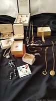 Overview of assorted jewelry including necklaces, bracelets, earrings, and boxed pieces.