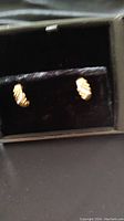 Two 10K yellow gold rope twist earrings in black velvet case