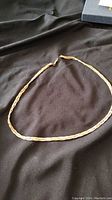 Full view of 19 inch gold plated twisted rope chain necklace laid out with clasp visible.