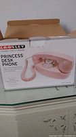 Photo of the Crosley Princess Desk Phone box showing the phone image, brand, and model name.