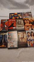 Photo of 10 VHS tapes and DVDs including Spider-Man, Home Alone, The Lord of the Rings trilogy, and Dawson's Creek seasons 3 and 4.