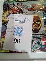 Close-up of condition note and title on the comic book cover with auction tag.