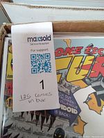 Close-up of comic book cover showing 'Contessa Fury' with colorful characters and text, comics are bagged and boarded.