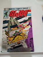 Front cover showing G.I. Joe comic book issue #13 with military action scene including jeep, helicopter, and soldiers.