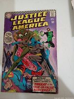 Front cover of Justice League of America comic issue #49 showing main characters and title.