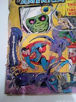 Front cover of Justice League America comic book showing Superman, Batman, and other characters in battle scene with visible edge wear and discoloration.