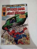 Photo of full front cover showing Spider-Man trapped in webbing below a helicopter piloted by Black Panther with clear Marvel Team-Up branding and issue #87.