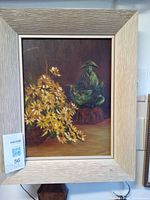 Front view of the oil painting showing the daisies and teapot with frame.