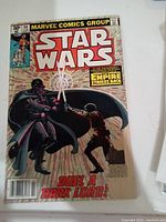 Front cover photo of Star Wars comic issue #44 showing Darth Vader and Luke Skywalker with lightsabers, title and price visible, with front cover damage