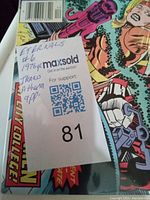 Close-up showing seller's note on the comic confirming issue number and year with additional character detail