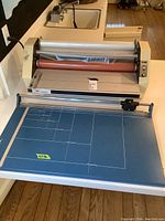 Full view of GBC roll laminator with attached blue cutting board