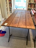 Full view of table showing wood top and metal base