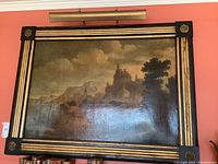 Front view of entire oil painting in gilt wood frame against a salmon-colored wall.