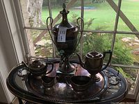 Full service arranged on oval tray in front of window