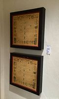 Closed wooden spice racks mounted on wall, showing framed herb and spice usage charts on the front panels.