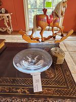 Orrefors crystal bowl shown on a table with a wooden rocking horse in background