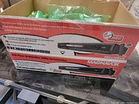 Box showing product branding and features including 1080p up-conversion and playback formats.