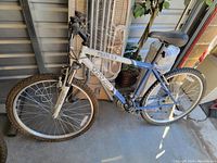 Full side view of men's Titan Trail 2.0 mountain bike showing frame, tires, pedals, and seat.