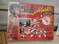 Photo of the Bob Ross Master Paint Set box front, showing content images and Bob Ross portrait.