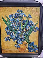 Full view of oil on canvas painting showing the blue iris bouquet in orange vase with yellow background