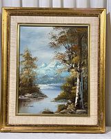 Front view of framed original vintage landscape painting signed by F. Stutzer featuring trees and snowcapped mountains.