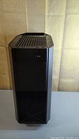 Front view of the black Alienware tower computer case showing ventilation grills and Alienware logo.