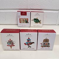 Photo of all 5 Hallmark miniature ornaments in their original boxes showing front and design names.