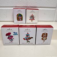 Front of the 5 Hallmark Keepsake miniature ornament boxes showing designs and labels.