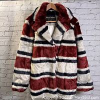 Front view of Juicy Couture Black Label striped faux fur coat, showing horizontal burgundy, white, and black stripes, collar, and button closure.