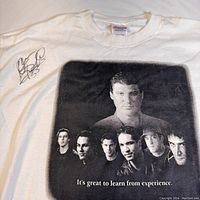 Front detail of white T-shirt with black and white graphic of Mario Lemieux and smaller images, text 'It's great to learn from experience.' Signature on left shoulder