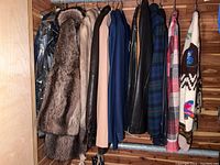 Row of assorted coats and jackets hanging on rod